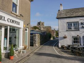 A street view with a coffee shop and a church in Ayside near Newby Bridge