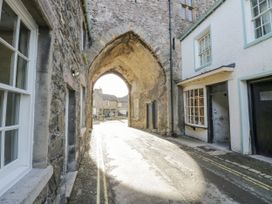 An archway with stone walls and buildings at Low House Cottage Ayside near Newby Bridge