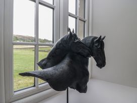 A sculpture of two horse heads in a room at Low House Cottage Ayside near Newby Bridge