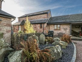 An outdoor view of a house with stones and plants at The Wren's Nest in Ross-on-Wye