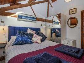 A bedroom with a bed and pillows at The Wren's Nest in Ross-on-Wye