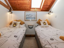 A bedroom with two single beds and a painting at The Wren's Nest in Ross-on-Wye