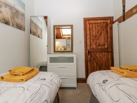 A bedroom with two beds and a dresser at The Wren's Nest in Ross-on-Wye
