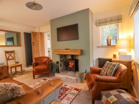 A living room with a fireplace and sofa at Bridge House Cottage Burn Bridge near Harrogate