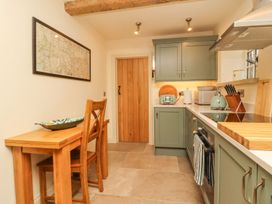 A kitchen with cabinets and appliances at Bridge House Cottage Burn Bridge near Harrogate
