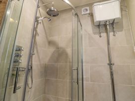A shower setup with a glass enclosure and controls at Bridge House Cottage Burn Bridge near Harrogate