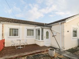 An outdoor space with a table and chairs at Primrose Cottage in Chathill
