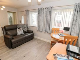 A living room with a sofa and table at Primrose Cottage in Chathill