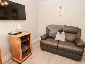 A living room with a sofa and television at Primrose Cottage in Chathill