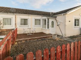 A house exterior with a patio and seating area at Primrose Cottage in Chathill