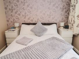 A bedroom with a bed and bedside tables at Megstone in Chathill