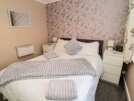 A bedroom with a bed and nightstand at Megstone in Chathill