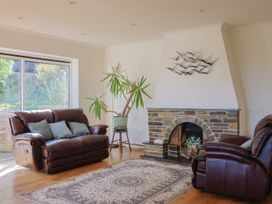 A living room with a sofa and fireplace at Hawksdown in Lyme Regis