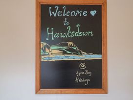 A welcome sign on a chalkboard at Hawksdown at Lyme Bay Holidays