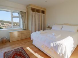 A bedroom with a bed and dresser at Hawksdown in Lyme Regis
