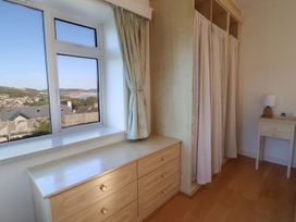 A bedroom with a dresser and window at Hawksdown Lyme Regis