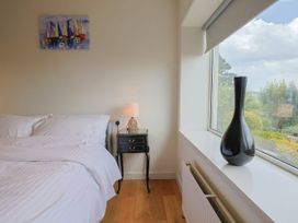 A bedroom with a bed and nightstand at Hawksdown in Lyme Regis