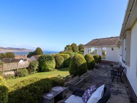 A patio with bushes and a view of the sea at Hawksdown in Lyme Regis