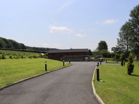 A house and driveway with lamp posts at Holly Lodge in Lloc near Caerwys