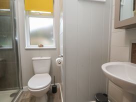 A bathroom with a toilet and sink at Pine Lodge in Lloc near Caerwys
