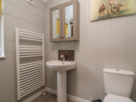 A bathroom with a sink, toilet, and radiator at Pine Lodge Lloc near Caerwys