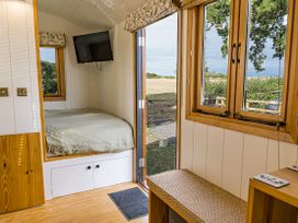 A bedroom with a bed and television at No 2 The Parkland in Upton Warren