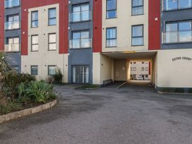 A building entrance with windows and parking area at Astor Court in Newquay