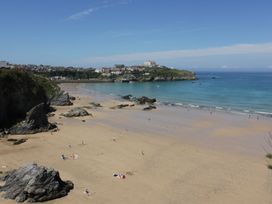 A beach with sand and water at Sea Snug in Newquay