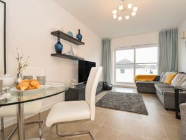 A living room with a dining table and sofa at Sea Snug in Newquay