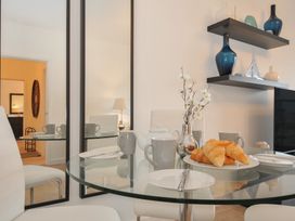 A dining table set with croissants and tea at Sea Snug in Newquay