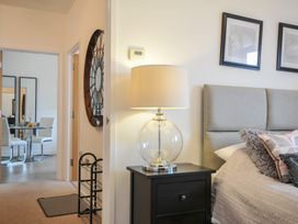 A bedroom with a lamp and nightstand at Sea Snug in Newquay