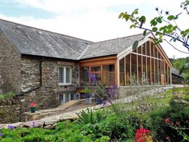 A building with large windows and a garden at The Cider Barn at Home Farm Down Thomas near Wembury
