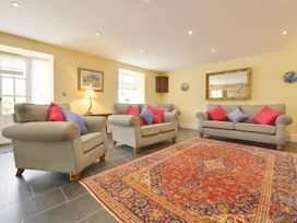 A living room with sofas and a rug at The Cider Barn at Home Farm Down Thomas near Wembury