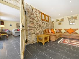 A living room with a sofa and coffee table at The Cider Barn at Home Farm Down Thomas near Wembury