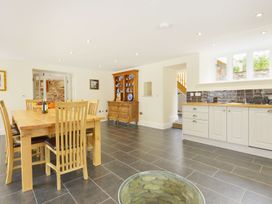 A kitchen with a dining table and sideboard at The Cider Barn at Home Farm Down Thomas near Wembury