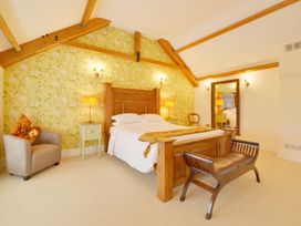 A bedroom with a bed and furniture at The Cider Barn at Home Farm Down Thomas near Wembury