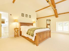 A bedroom with a bed and lamp at The Cider Barn at Home Farm Down Thomas near Wembury