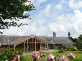 A building in a garden at The Cider Barn at Home Farm Down Thomas near Wembury