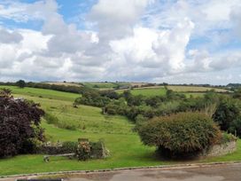 A landscape view with fields and trees at The Cider Barn at Home Farm Down Thomas near Wembury