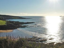 A coastal view with a beach and water at The Cider Barn at Home Farm Down Thomas near Wembury