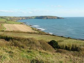 A coastal landscape with fields and the sea at The Cider Barn at Home Farm Down Thomas near Wembury