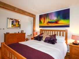 A bedroom with a wooden bed and dresser at Kerslake House Crafthole