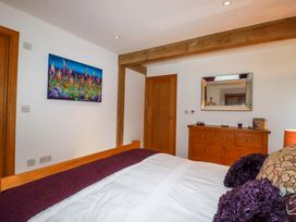 A bedroom with a bed and a mirror at Kerslake House in Crafthole