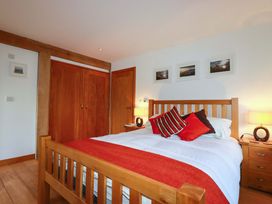 A bedroom with a bed and wardrobe at Kerslake House Crafthole