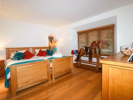 A bedroom with two beds and a rocking horse at Kerslake House in Crafthole