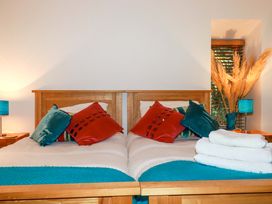 A bedroom with two beds and decorative pillows at Kerslake House in Crafthole