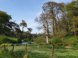 A natural landscape with a river and trees at Kerslake House in Crafthole