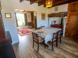 A dining room with a table and chairs at Halwyn Farm in Helston