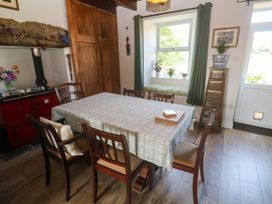 A dining room with a table and chairs at Halwyn Farm in Helston