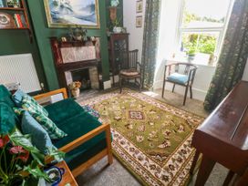 A living room with a rug and sofa at Halwyn Farm in Helston